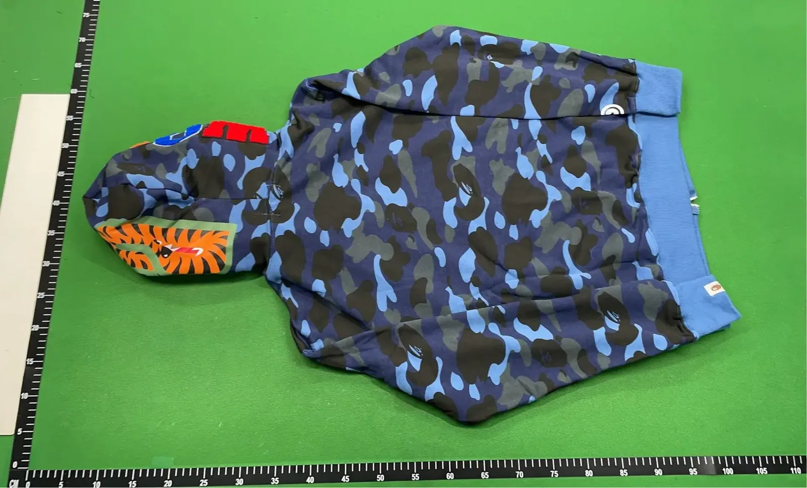 Kakobuy QC camouflage hoodie back view with ruler