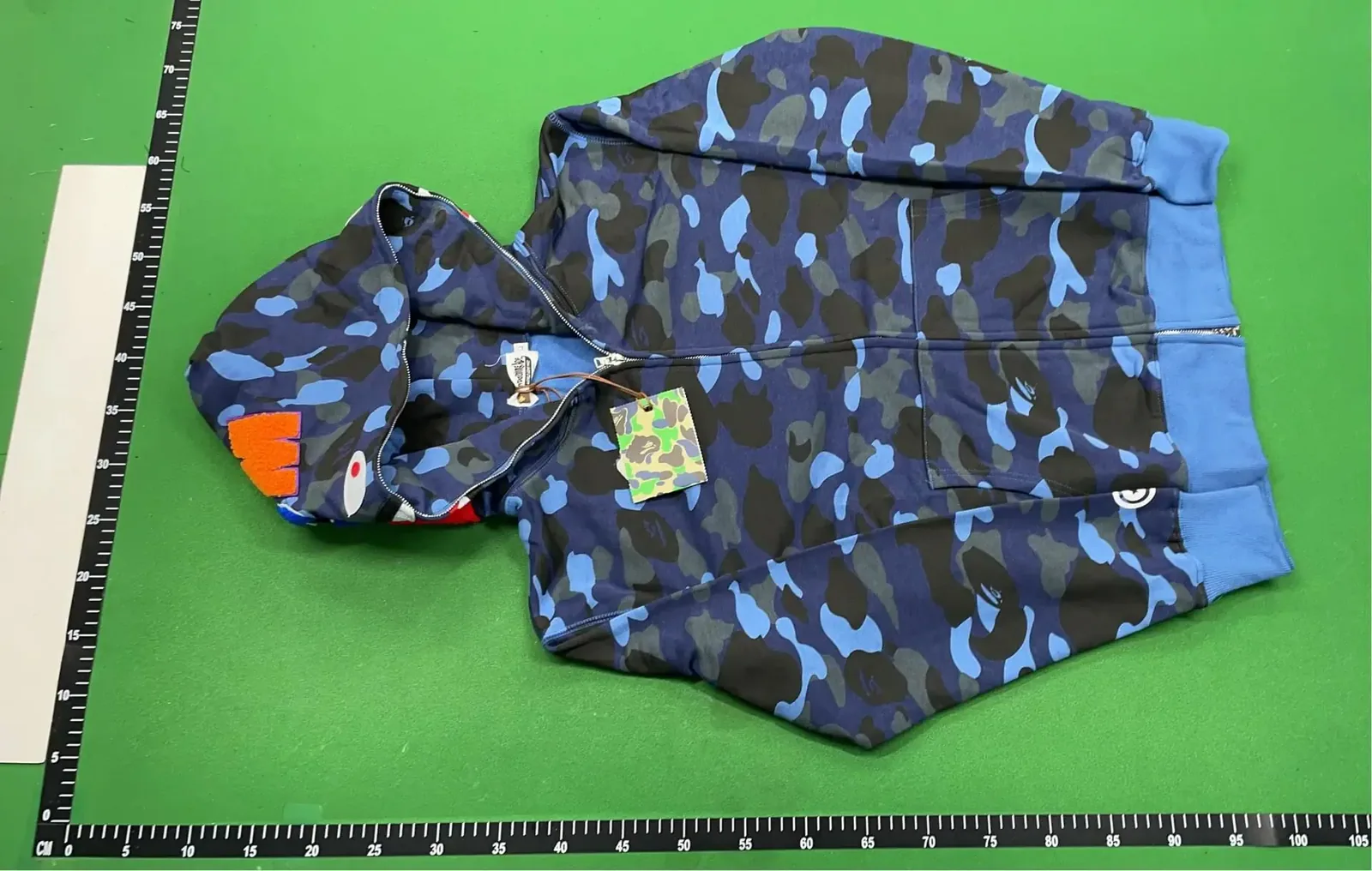 Kakobuy QC camouflage hoodie front view with ruler