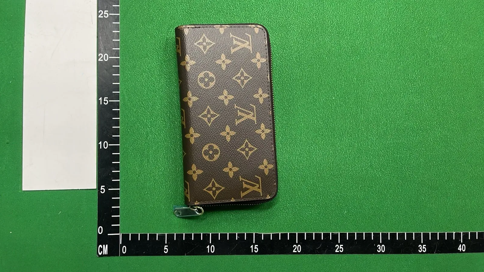 Kakobuy QC wallet vertical view with ruler for scale